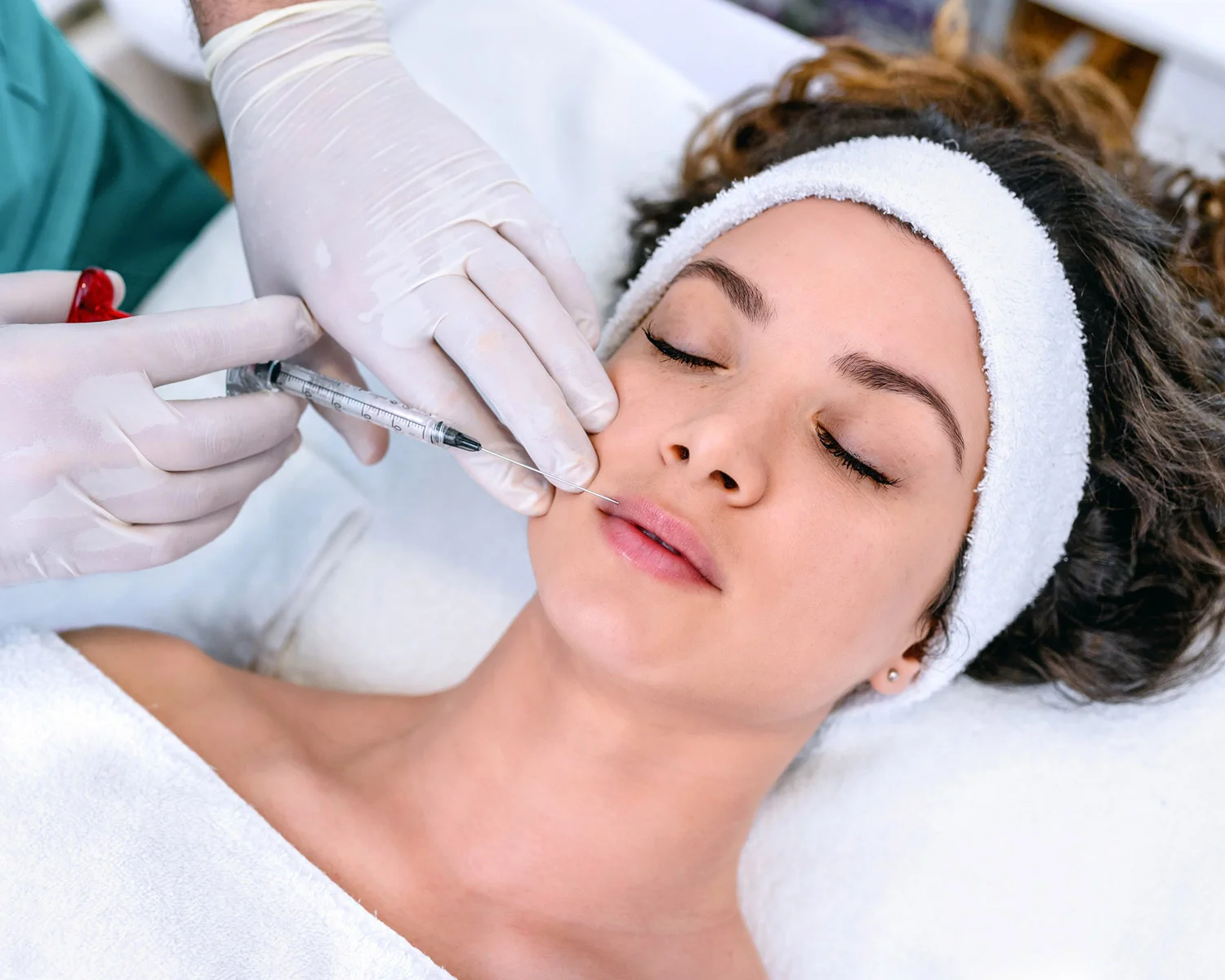 Woman getting dermal filler injections