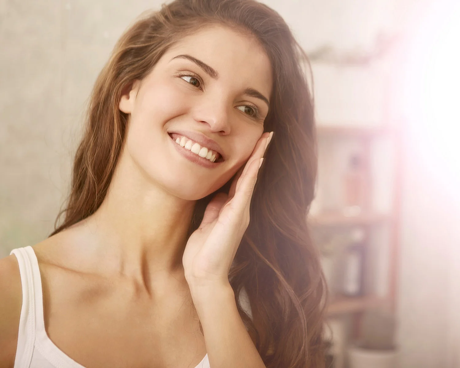 Woman holding her face and looking in the mirror