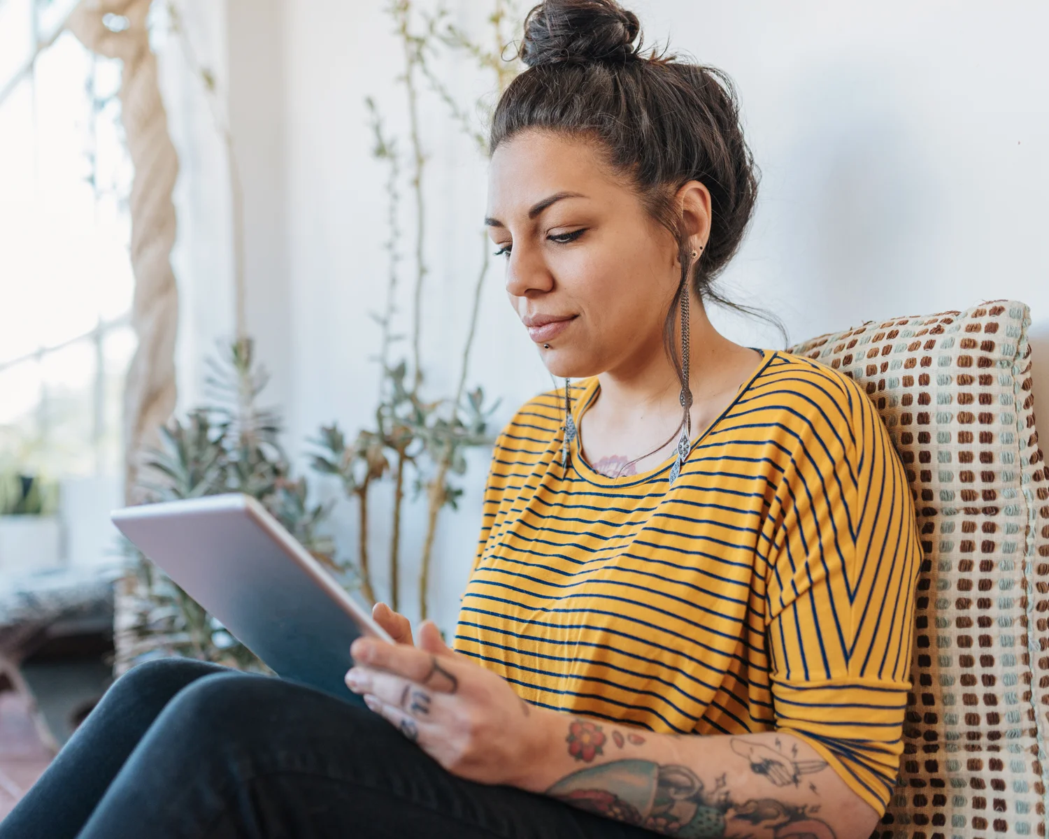 Woman with tattoos sitting at her laptop